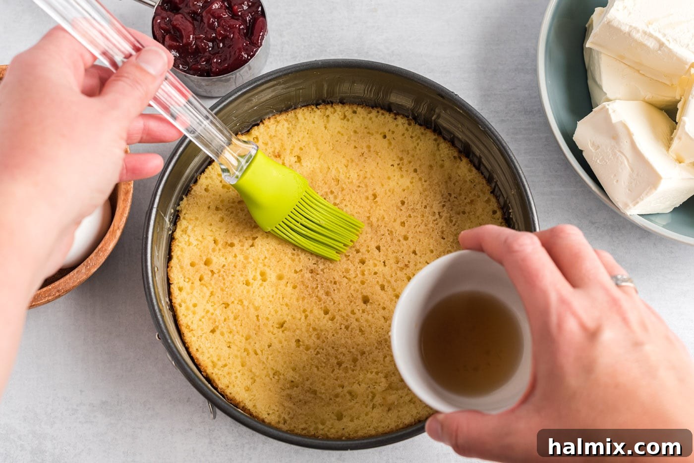 Regal Trifle Cheesecake 6 Brushing yellow cake with cream sherry for the trifle layer