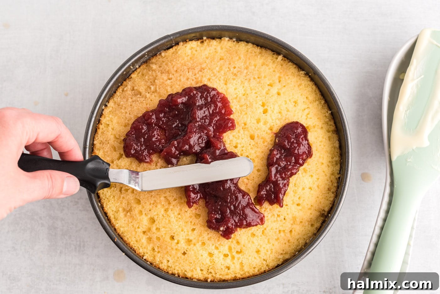 Regal Trifle Cheesecake 10 Spreading raspberry preserves over the second cake layer