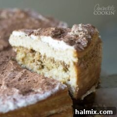 Removing a slice of Tiramisu Cheesecake, showing its perfect layers