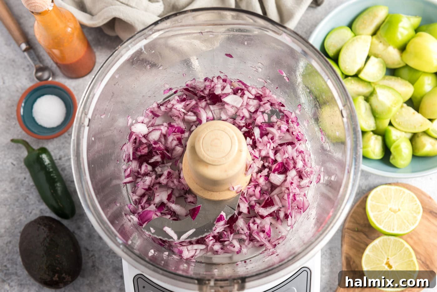 Diced red onion in a food processor, ready for the next steps