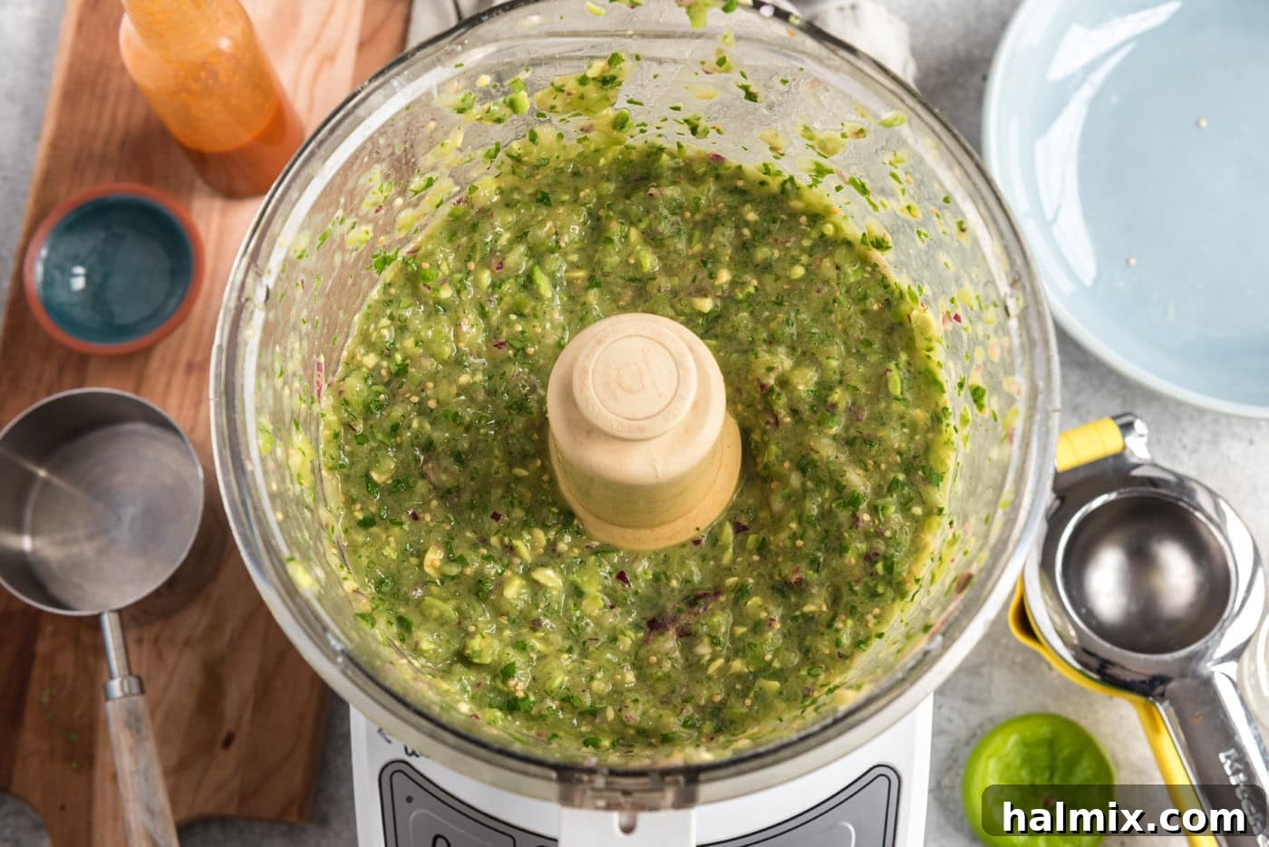 Perfectly blitzed tomatillo avocado salsa in a food processor, creamy and vibrant