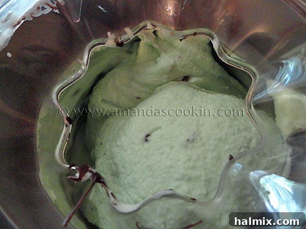 ice cream maker A close up of a ice cream maker churning ice cream, highlighting the motion and the developing texture of the dessert.