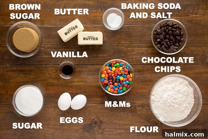 All the key ingredients laid out for delicious M&M cookies. A curated display of ingredients for chocolate chip M&M cookies, including flour, sugars, butter, eggs, and candies.