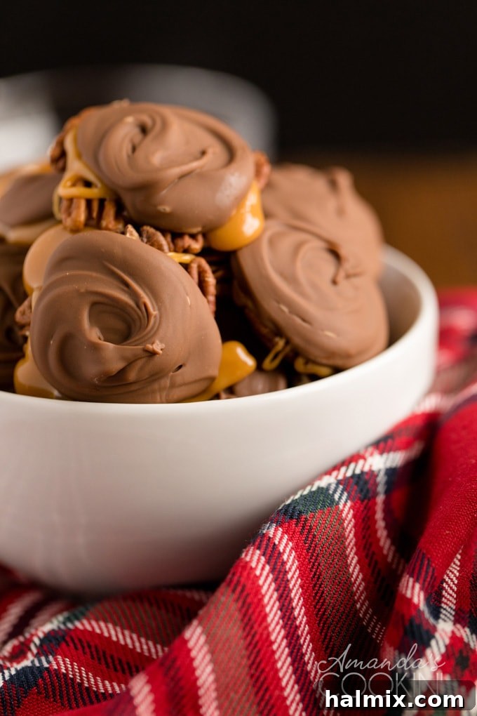 A ceramic bowl filled with freshly made homemade chocolate turtles, ready to be enjoyed.