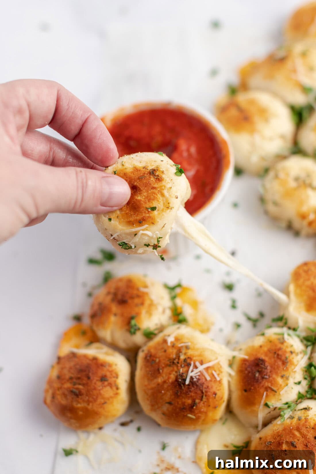 Festive Christmas Tree Pull-Apart Bread 3 Hand pulling off a piece of Christmas Tree Pull Apart Bread