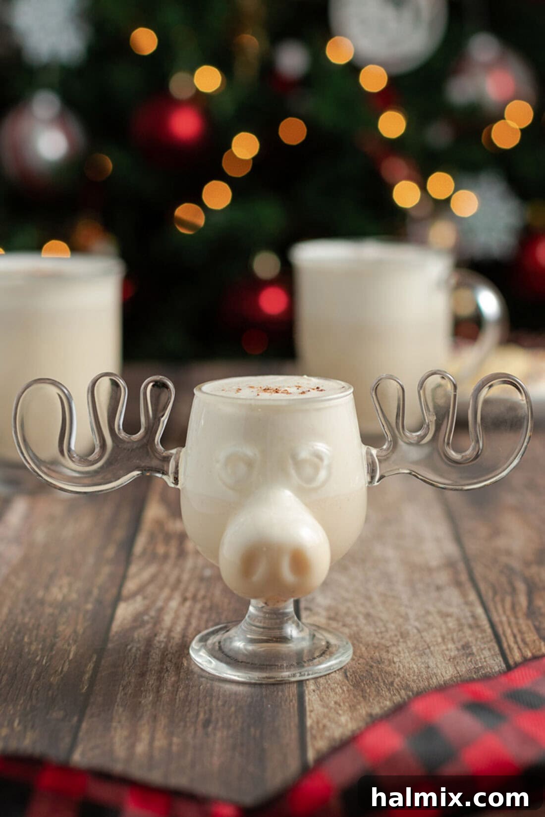 Homemade Eggnog in a reindeer mug, topped with freshly grated nutmeg