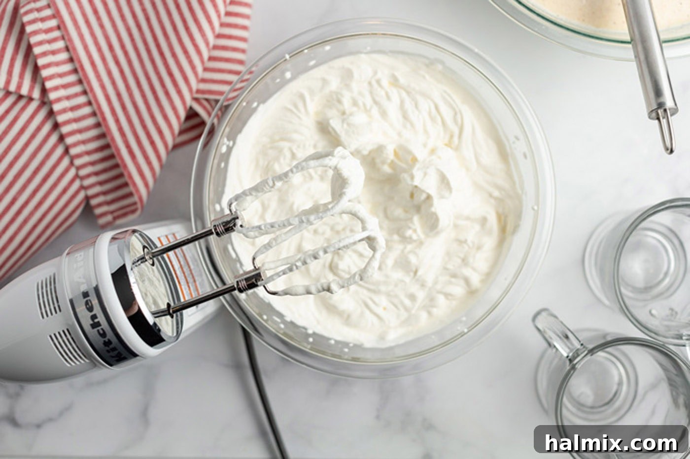 Heavy cream beaten to soft peaks in a mixing bowl