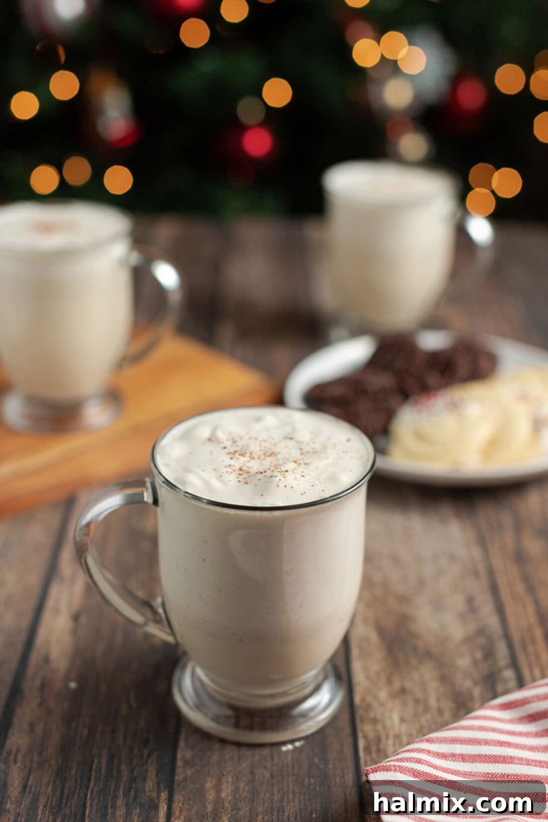 Mug of Homemade Eggnog with additional mugs in the background