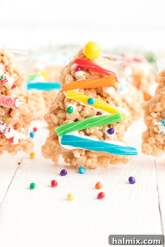 Decorate your Christmas Tree Rice Krispie Treats with an assortment of candies for a vibrant, festive look. rice krispie treat christmas tree decorated with various candies