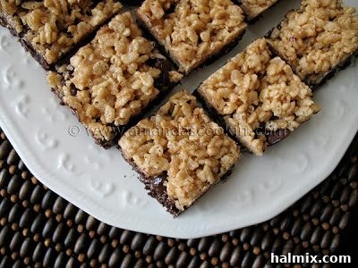 A close up photo of chewy cookie crunch bars on a white plate, showcasing their inviting texture.