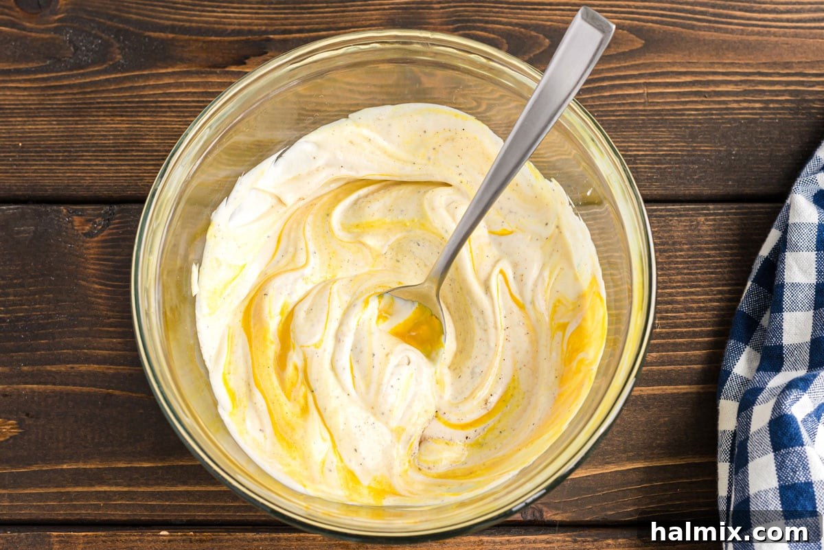 Mama's Secret Potato Salad 5 spoon in bowl of mayo and mustard