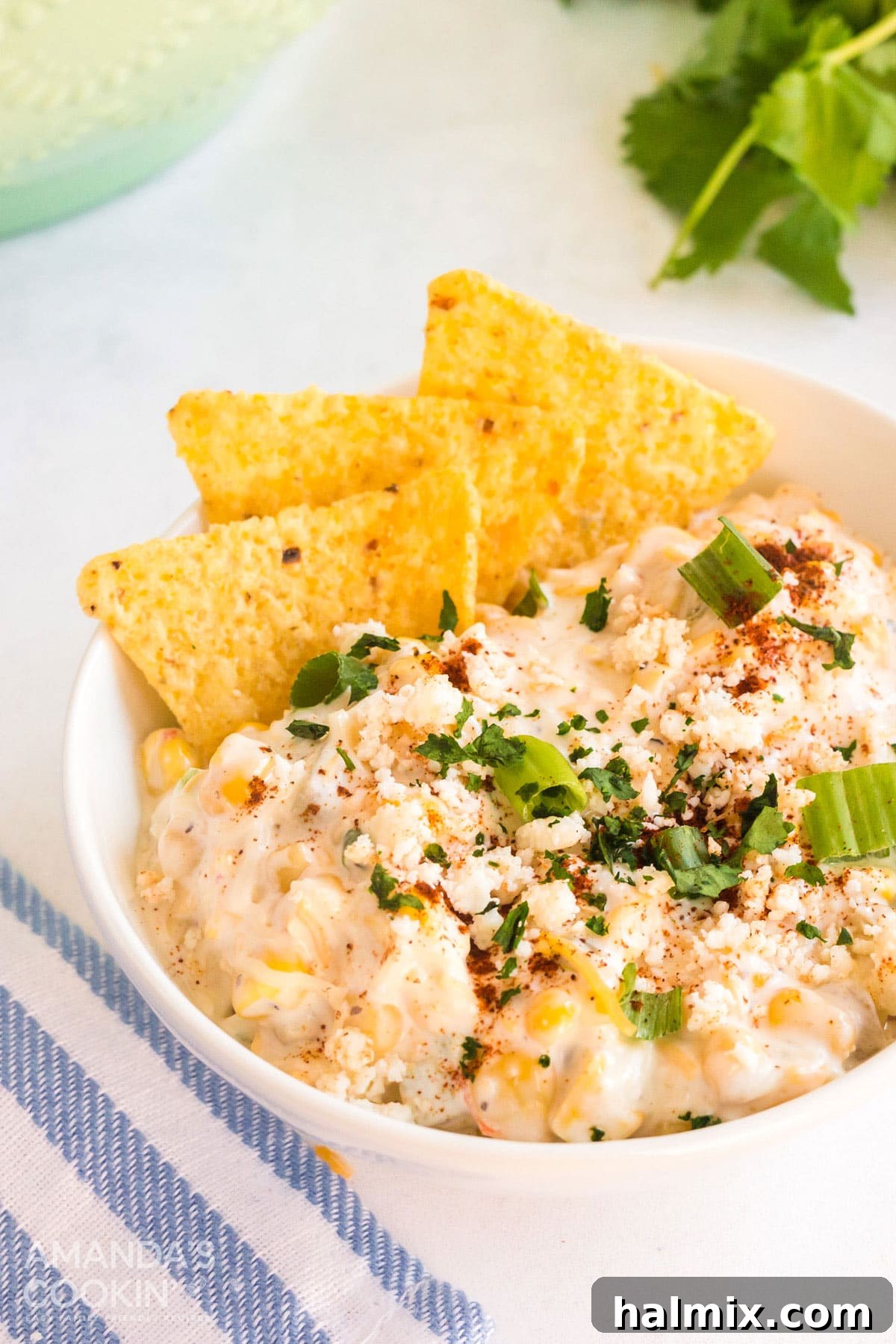 bowl of corn dip with tortilla chips placed in it