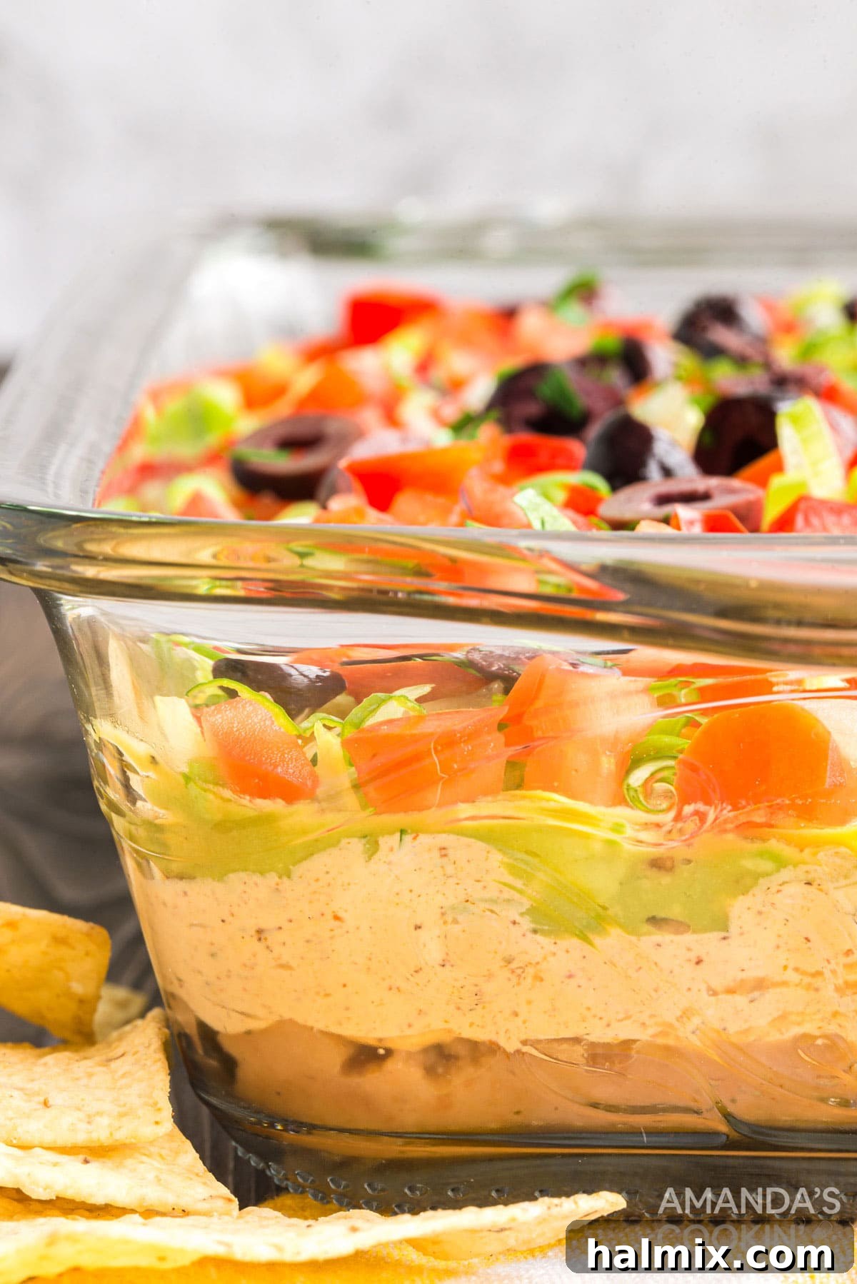 side view of glass pan with taco dip showing layers