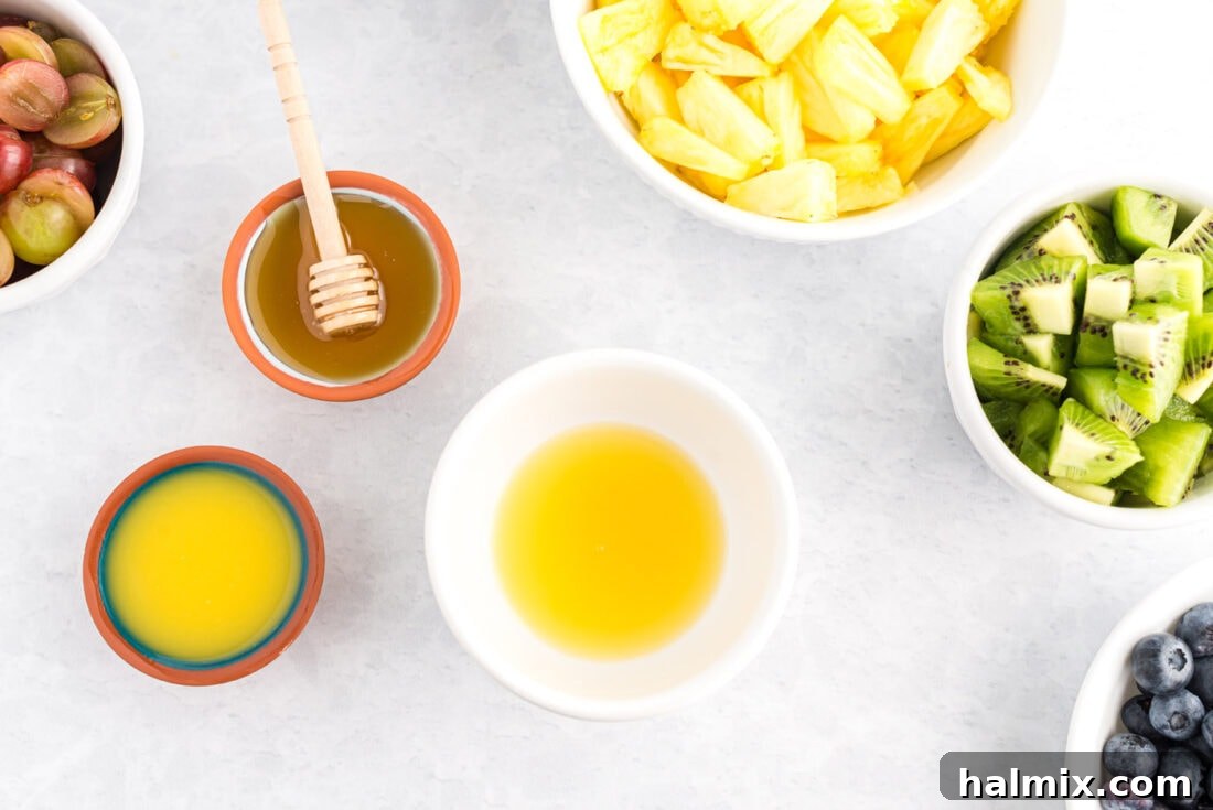 Rainbow Fruit Delight 3 Whisking orange juice, pineapple juice, and honey together for the fruit salad dressing