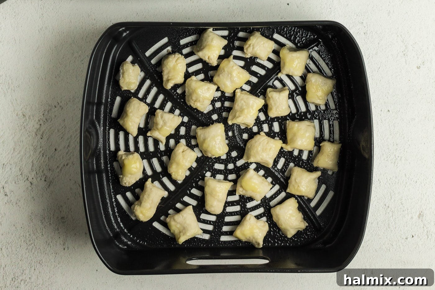 Golden Air Fried Pretzel Poppers 12 Pretzel dough bites in an air fryer basket
