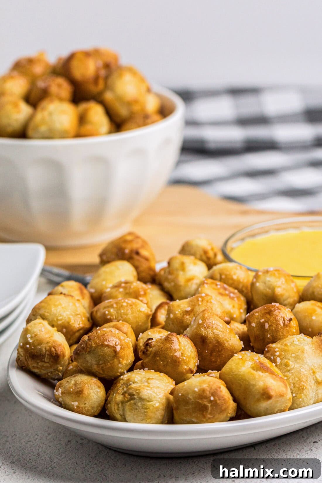 Golden Air Fried Pretzel Poppers 13 Plate of Air Fryer Pretzel Bites with more in a bowl in the background