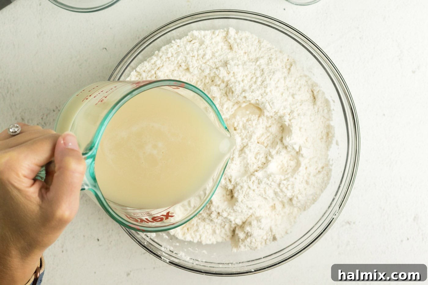 Golden Air Fried Pretzel Poppers 7 Yeast being poured into the flour mixture