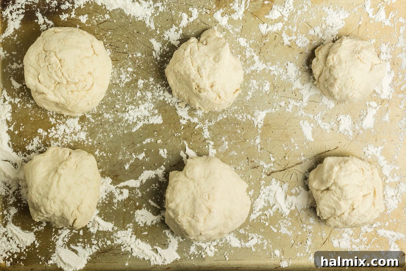 Golden Air Fried Pretzel Poppers 9 Floured cookie sheet with 6 dough pieces on it