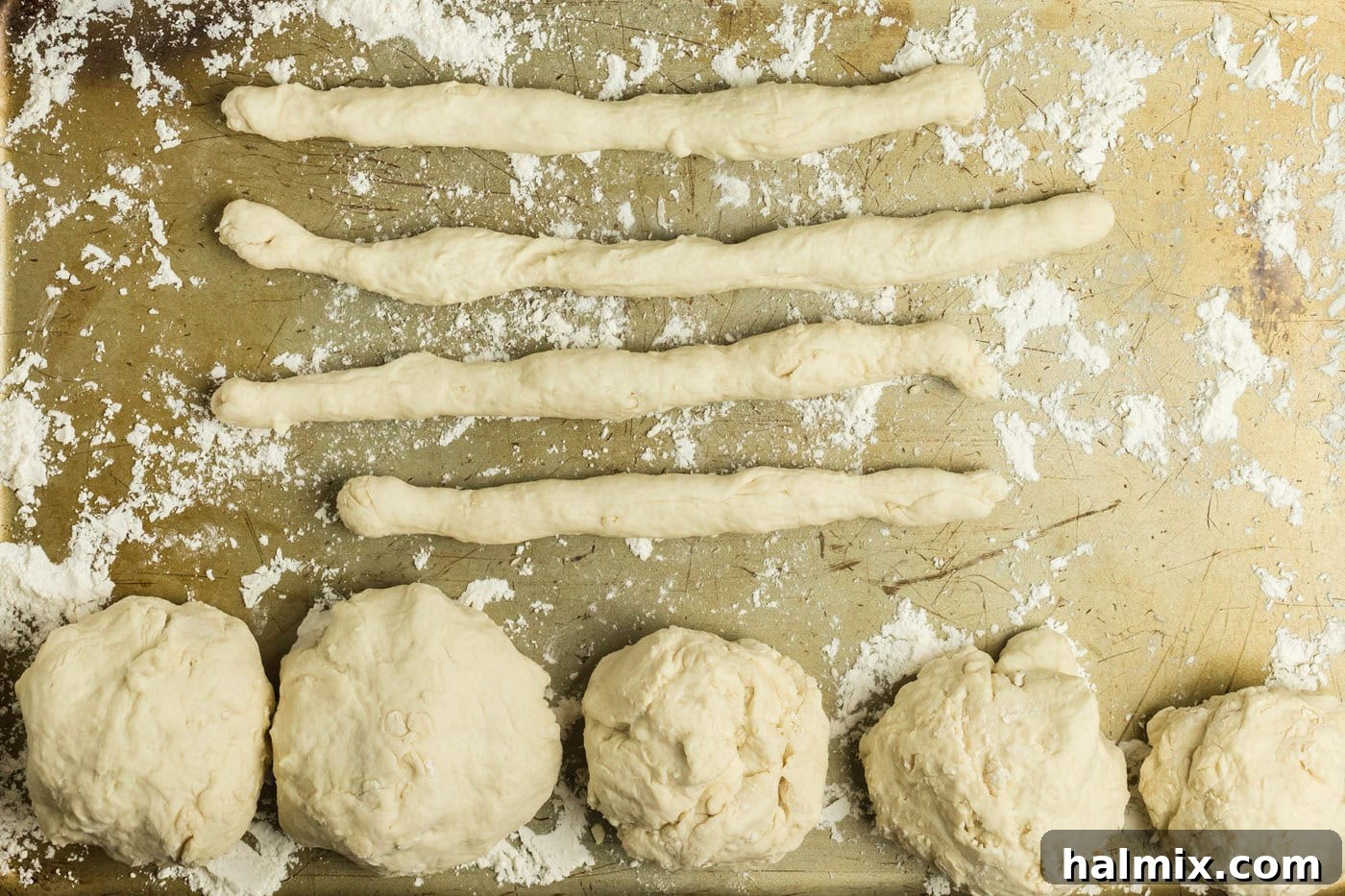 Golden Air Fried Pretzel Poppers 10 Ropes of dough and dough balls on a floured baking sheet