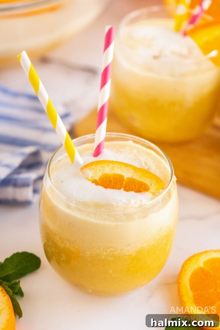 glass of orange punch with straws