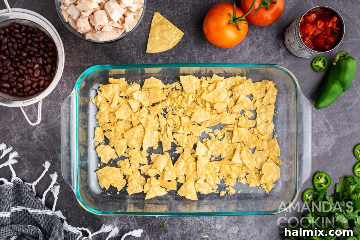 crushed tortilla chips in bottom of casserole dish