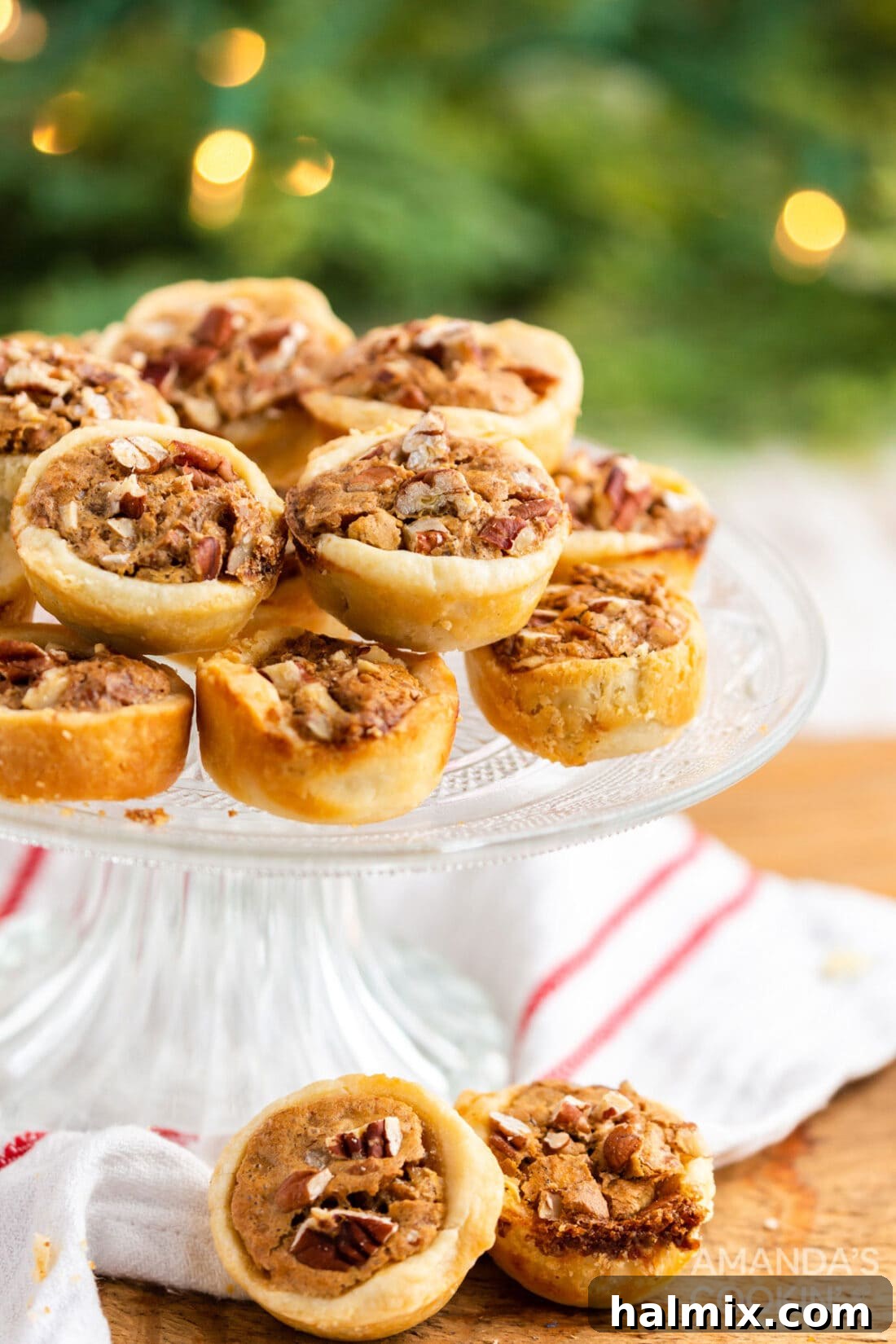 Delicious Pecan Tassies arranged on a beautiful cake plate, ready for serving.