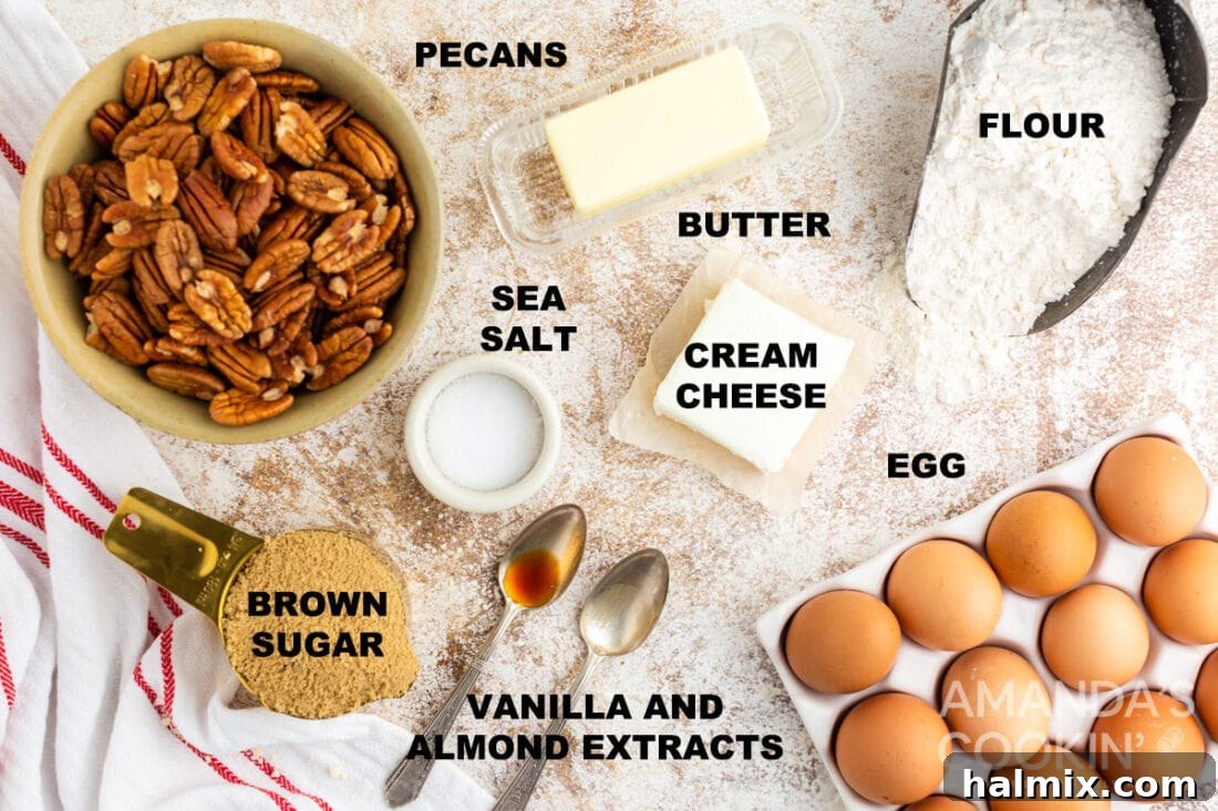 All the pre-measured ingredients laid out for making pecan tassie cookies, including butter, cream cheese, flour, eggs, sugar, extracts, and pecans.