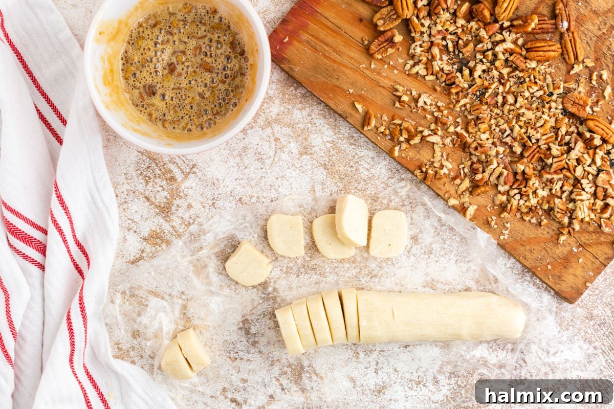 Chilled cookie dough log neatly sliced into uniform pieces.