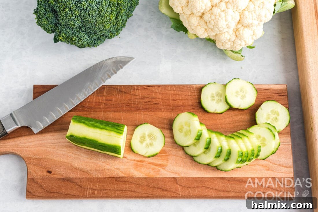 Edible Sculptures: Crafting Decorative Vegetables 4 Sliced striped cucumber rounds on a cutting board, showcasing a decorative peeling technique.
