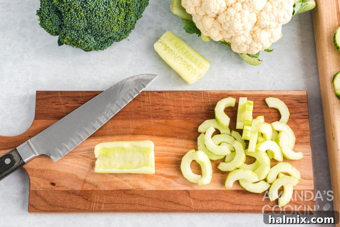 Edible Sculptures: Crafting Decorative Vegetables 5 Cored cucumber halves and slices on a cutting board, prepared for decorative use or filling.