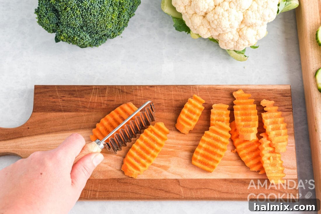 Edible Sculptures: Crafting Decorative Vegetables 6 A hand using a crinkle cutter to slice carrots into wavy shapes on a wooden cutting board.