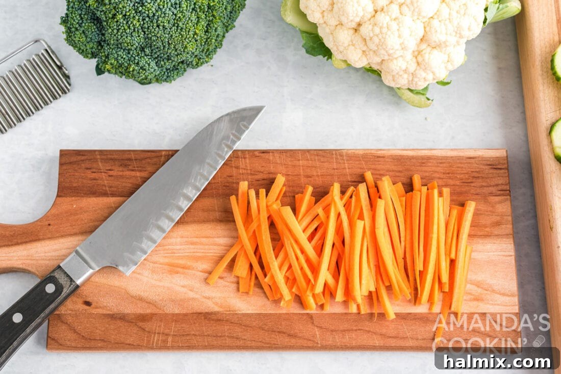 Edible Sculptures: Crafting Decorative Vegetables 7 Neatly julienned carrots arranged on a cutting board, ready for a vegetable platter.