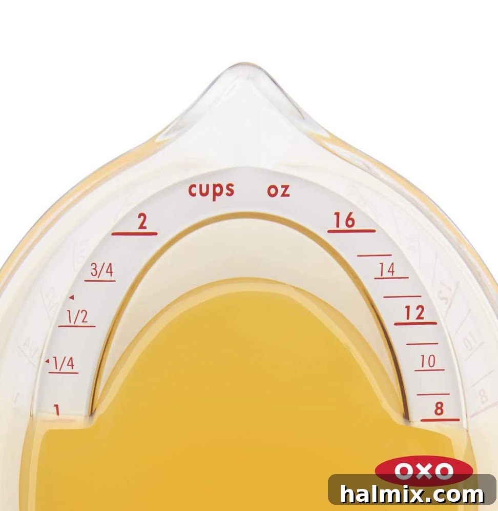 21 Clever Kitchen Gadgets You'll Use Constantly 6 Broth being accurately measured in an angled measuring cup, showing the ease of reading from above.