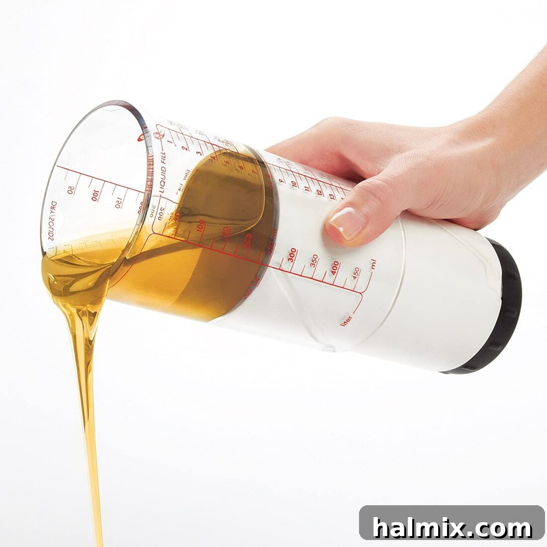 21 Clever Kitchen Gadgets You'll Use Constantly 7 Pouring honey from an adjustable measuring cup, demonstrating its ability to handle sticky ingredients without mess.