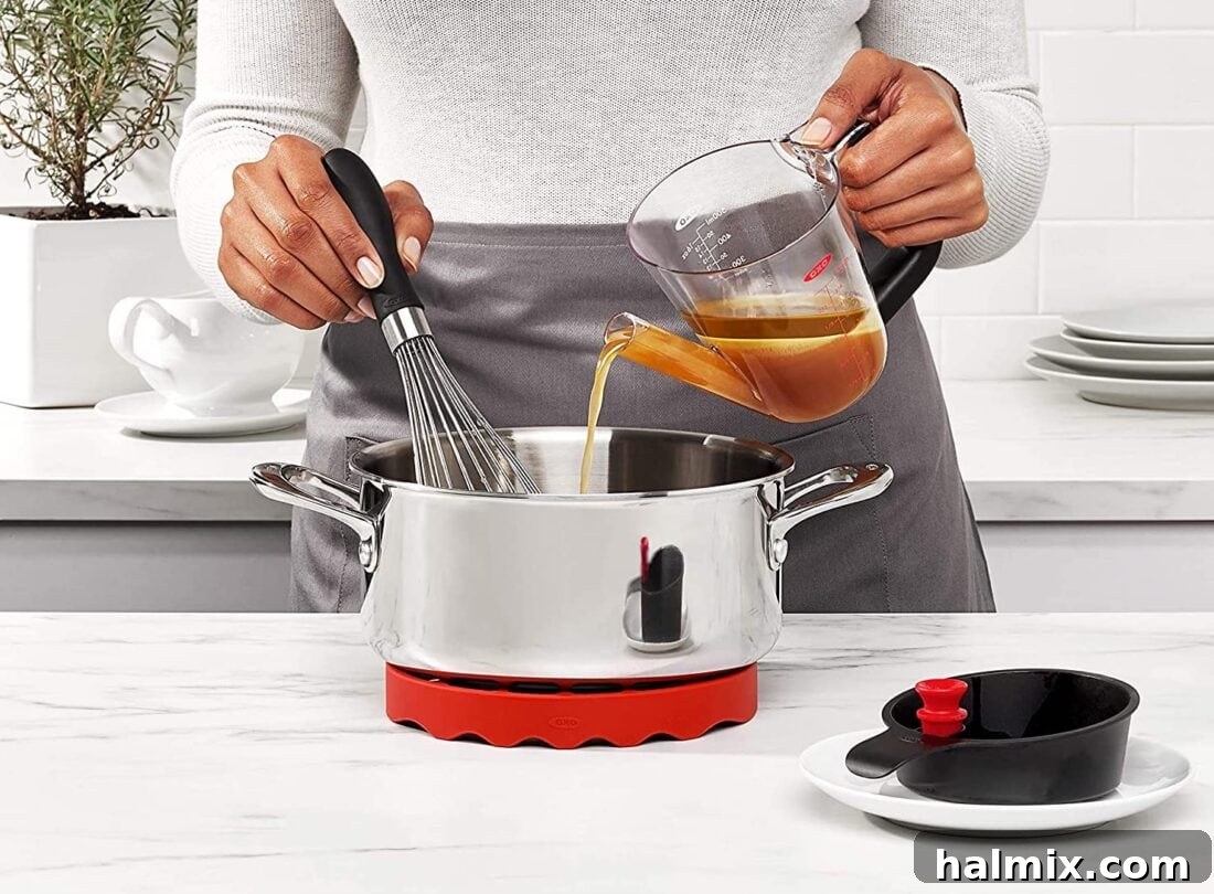 21 Clever Kitchen Gadgets You'll Use Constantly 8 Pouring broth from a fat separator, with the fat clearly separated at the top.