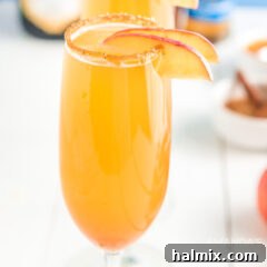 Champagne flute with caramel apple mimosa.