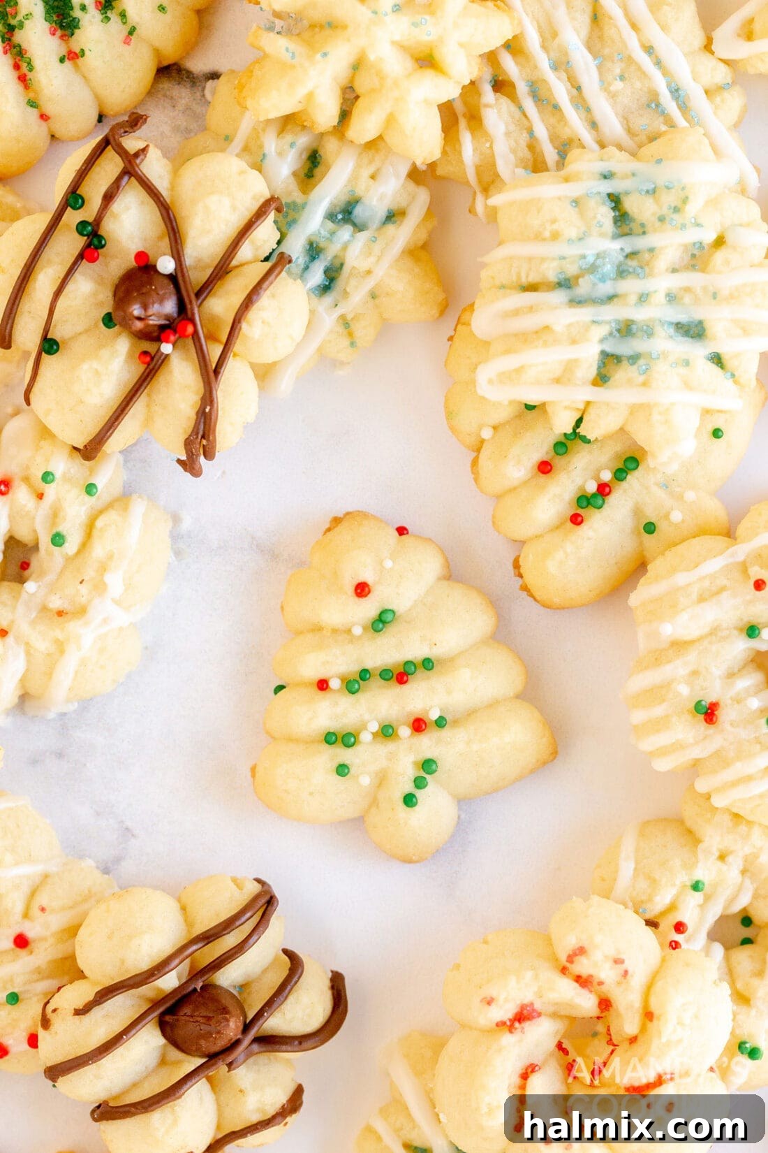 close up of a single perfectly formed spritz cookie with sprinkles