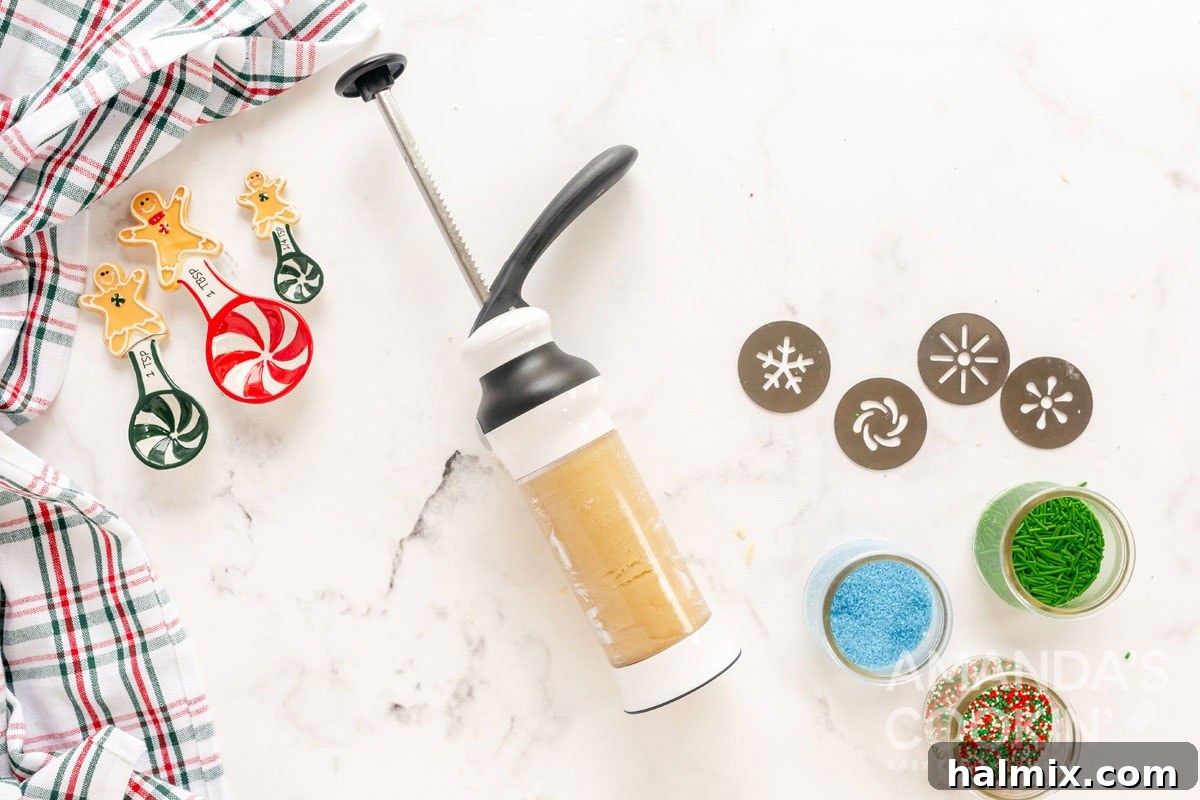 cookie dough being loaded into a cookie press