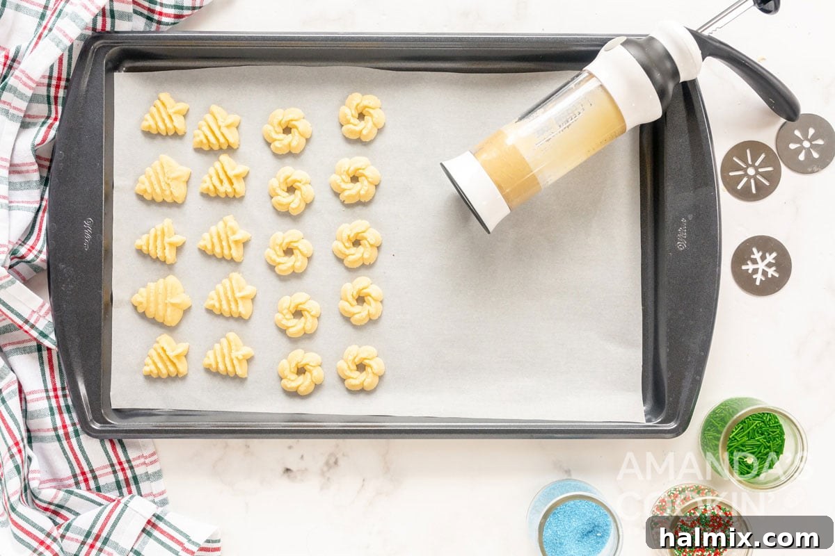 rows of neatly pressed spritz cookies on a baking sheet
