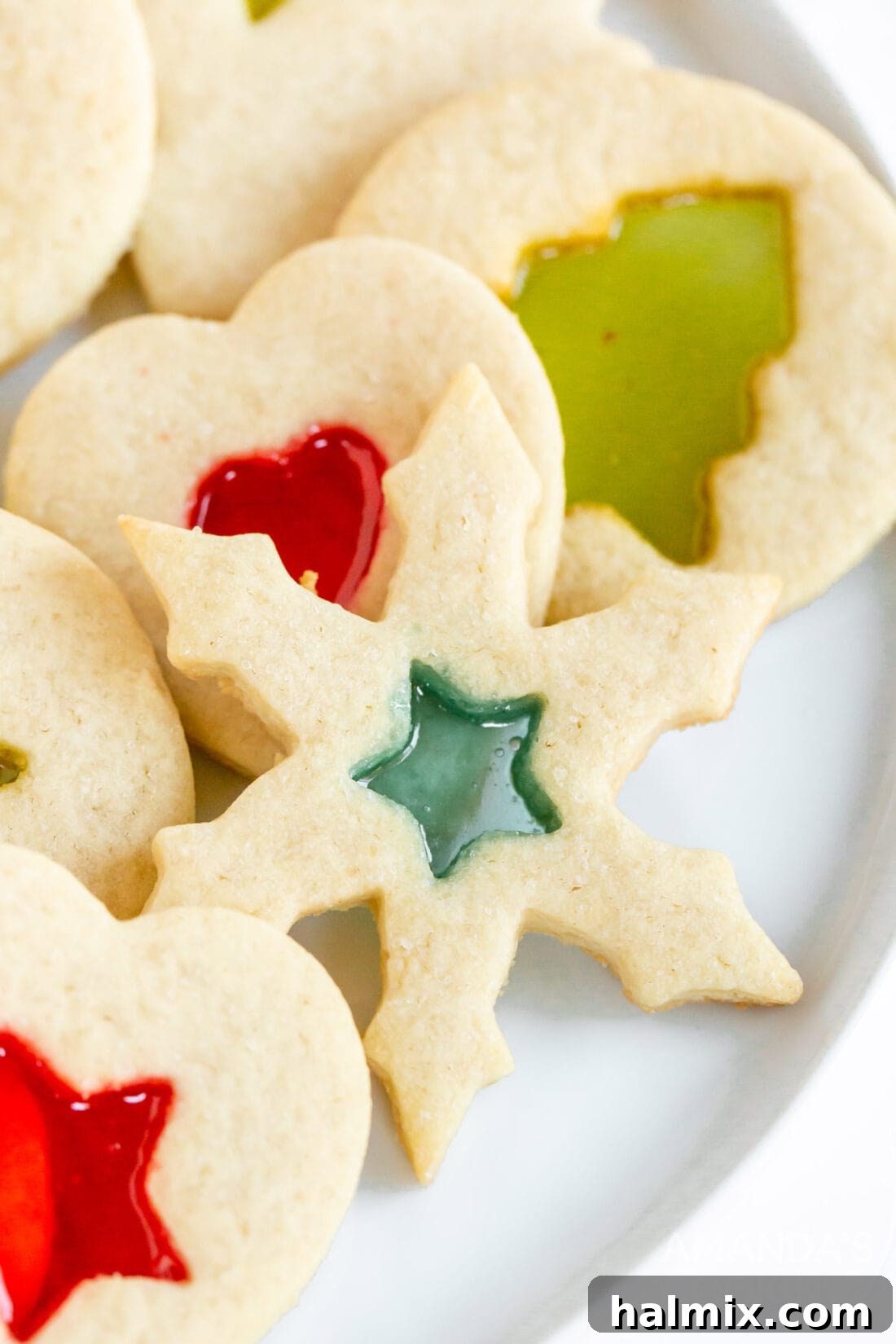Beautiful snowflake-shaped stained glass cookie glowing with melted candy center, perfect for holiday decoration or edible ornaments.