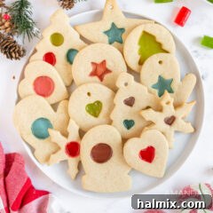 A plate of freshly baked stained glass cookies, showcasing their vibrant colors and festive appearance.