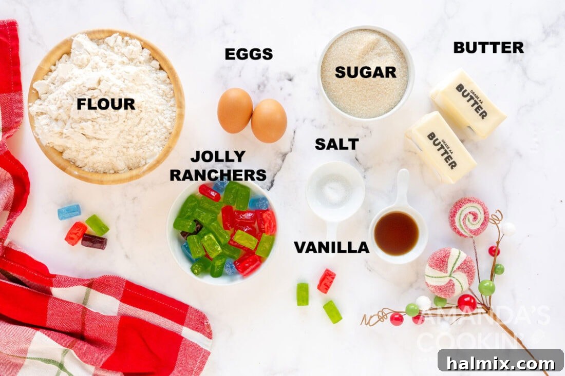 A collection of labeled ingredients including flour, butter, sugar, eggs, vanilla extract, and colorful Jolly Rancher candies, ready for making stained glass cookies.