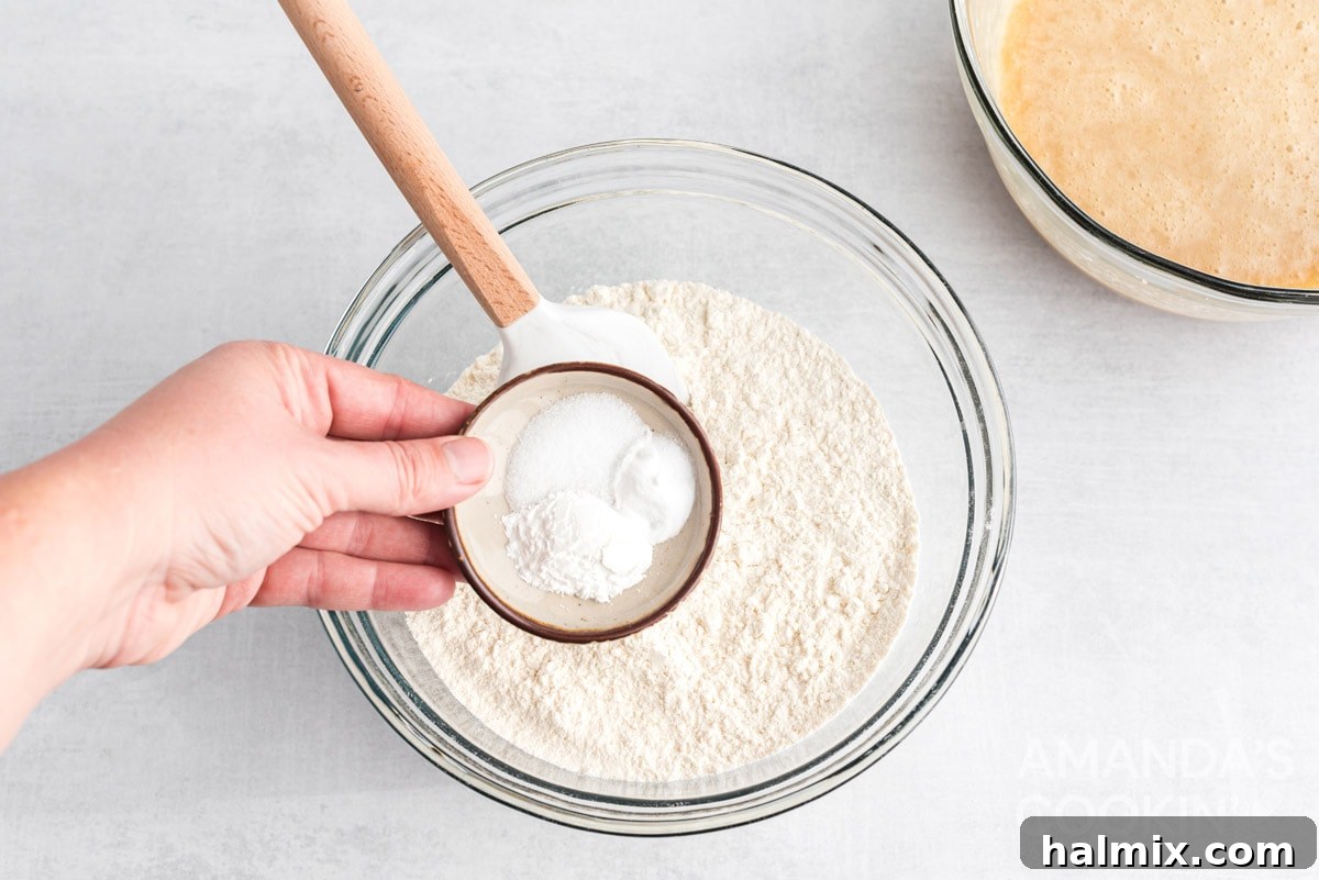Sweet-Tart White Chocolate Cranberry Delights 10 Adding baking powder to the dry ingredient mixture.