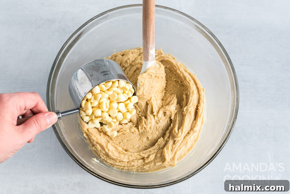 Sweet-Tart White Chocolate Cranberry Delights 12 Adding white chocolate chips to the cookie dough.