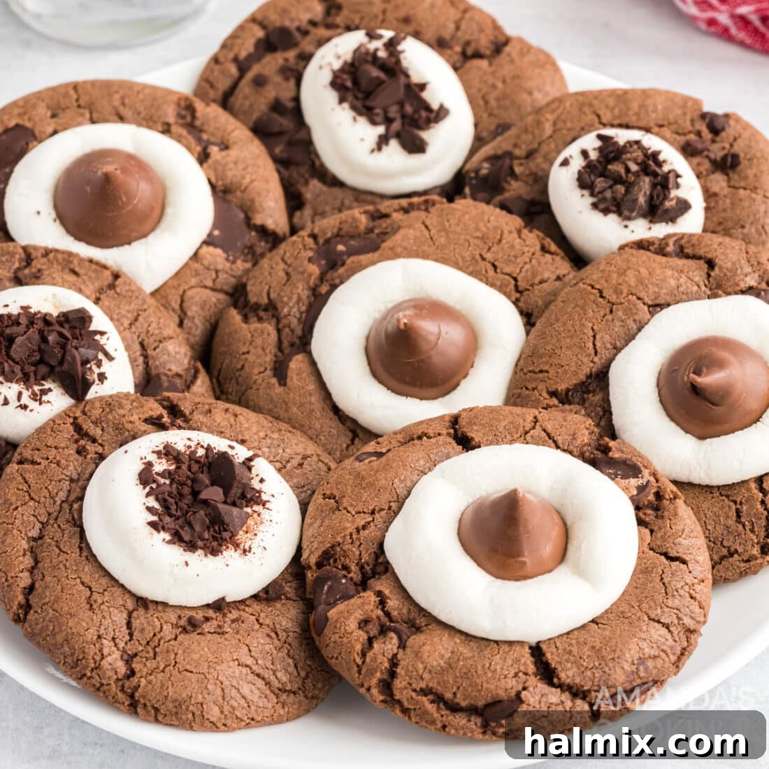 A delectable stack of hot cocoa cookies, featuring rich chocolate dough studded with mini marshmallows, ready to be enjoyed as a comforting winter treat.