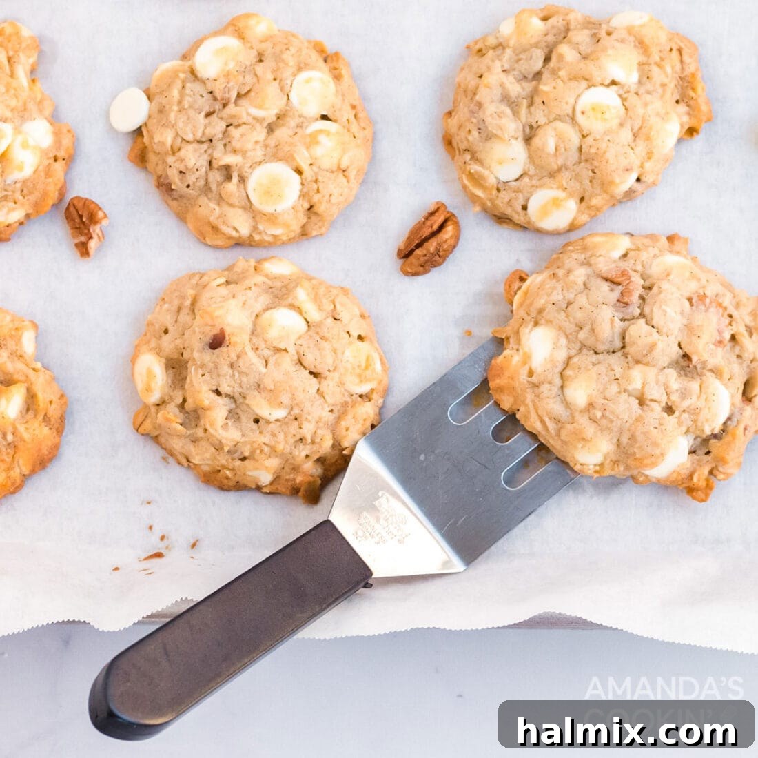 Freshly baked, soft banana cookies resting on a wire cooling rack, with a spatula nearby, inviting a warm and comforting treat.