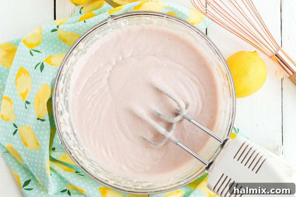 Pink cake batter in a mixing bowl, ready for baking