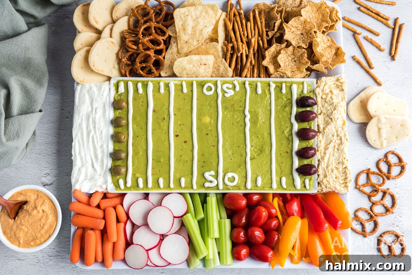 An inviting overhead view of the fully assembled football party tray, showcasing the guacamole field, end zone dips, and a generous assortment of dippers.