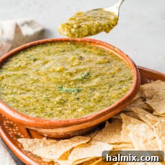 spoon lifting some salsa verde from bowl