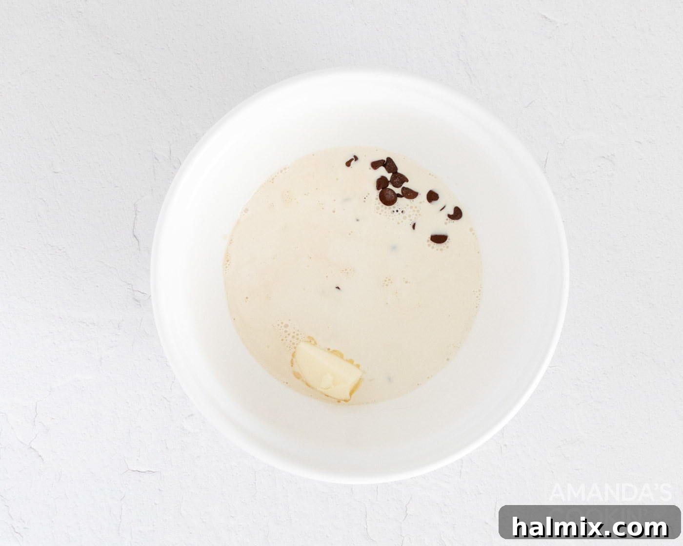Close-up of butter, semi-sweet chocolate, and cream already in a bowl, awaiting the whisking process to form the ganache for mocha truffles.